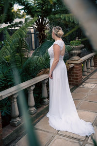 Rear view of woman standing by railing