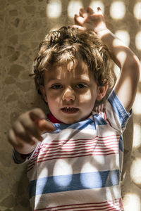 High angle portrait of cute boy lying on floor at home