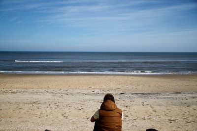 Man standing on beach against clear sky