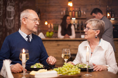 Portrait of senior couple sitting at restaurant