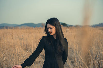 Young woman standing on field