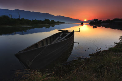 Scenic view of calm lake at sunset