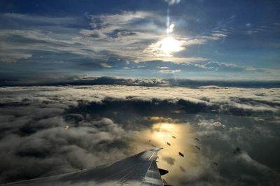 Aerial view of cloudscape over airplane wing