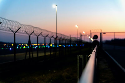 Close-up of railing against sky at night