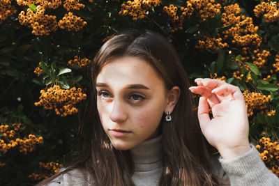 Portrait of woman with red flowers