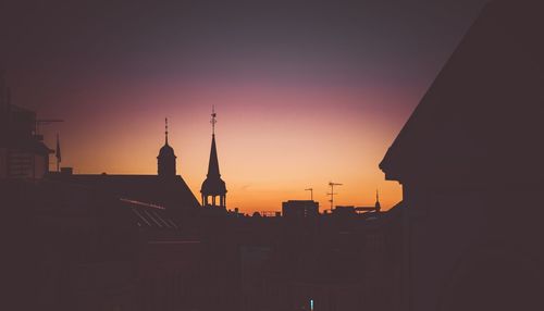 Silhouette of buildings against sky during sunset