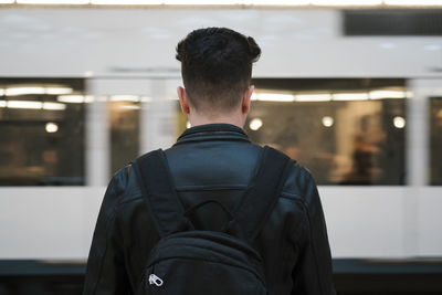 Young man with backpack at station