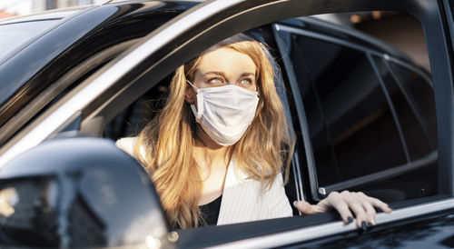 Portrait of woman sitting in car