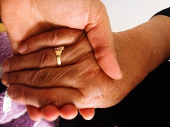 Midsection of couple holding hands