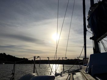 Boats in sea at sunset