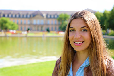 Portrait of smiling young woman in city