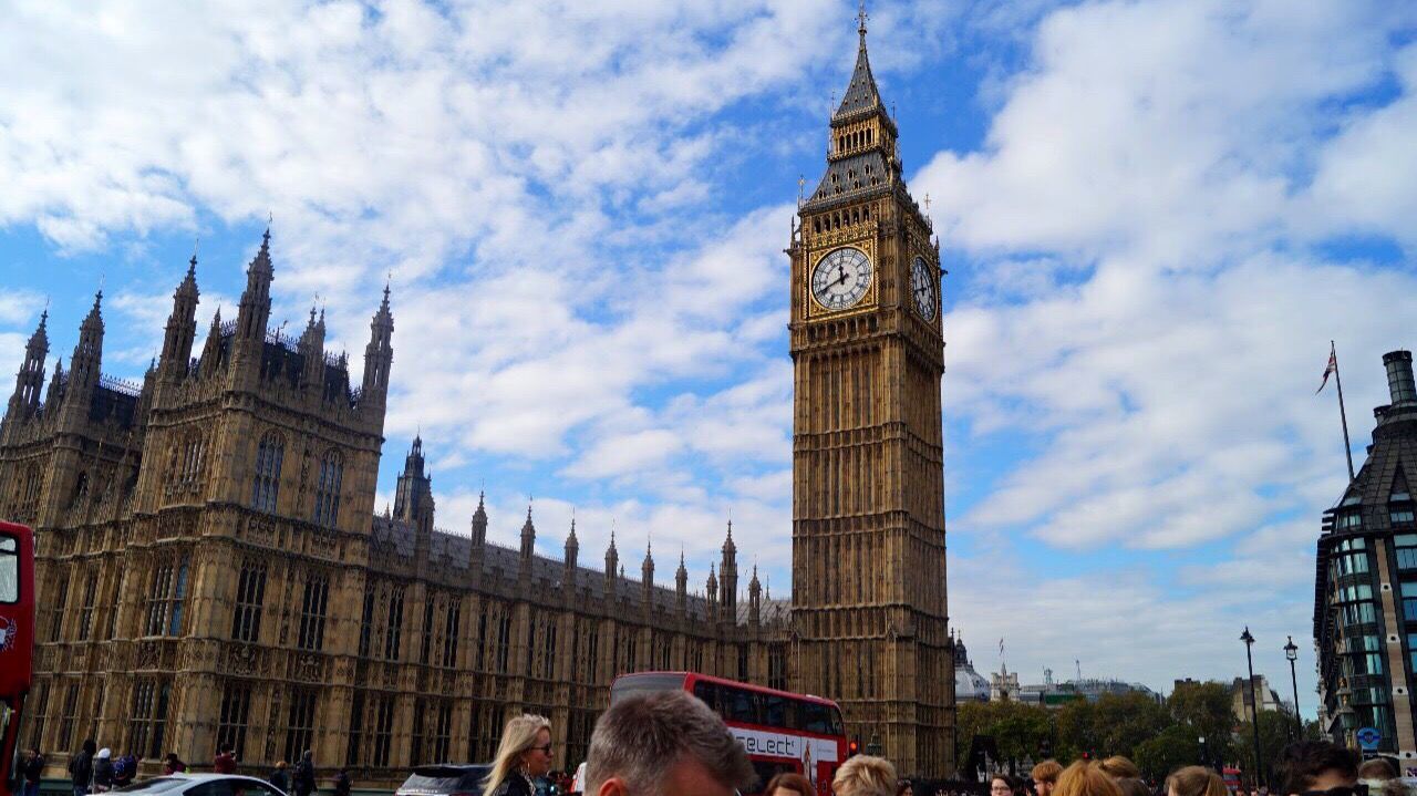 clock tower, travel destinations, architecture, sky, tourism, tower, government, built structure, travel, building exterior, cloud - sky, low angle view, large group of people, day, outdoors, group of people, politics, city, crowd, clock, politics and government, people, adult