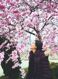 Woman with pink cherry blossoms in spring