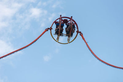 Low angle view of chain against sky