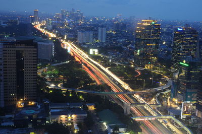 High angle view of illuminated cityscape against sky at night