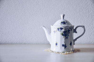 Close-up of drink on table against wall