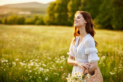 Young woman sitting on field