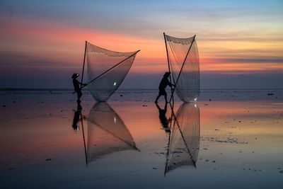Scenic view of beach against sky during sunset