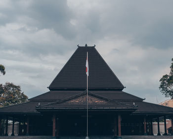 Low angle view of building against cloudy sky