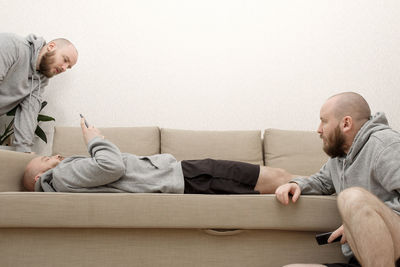 Side view of a man sitting on sofa
