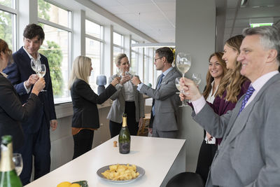 Business people celebrate with champagne