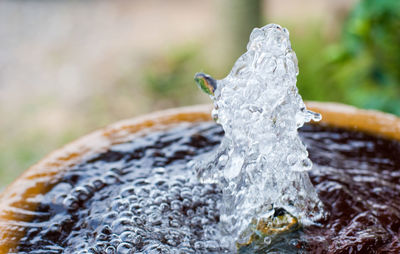 Close-up of water splashing on rock