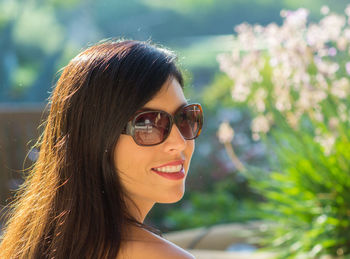 Close-up of smiling young woman in sunglasses