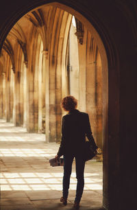 Rear view of woman walking in corridor