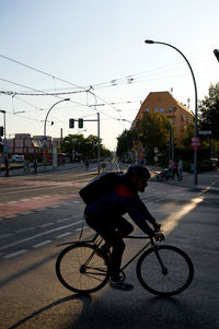 Man riding bicycle on city street