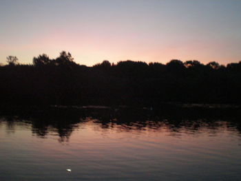 Scenic view of calm lake at sunset