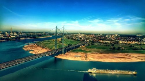 High angle view of bridge over river in city against sky