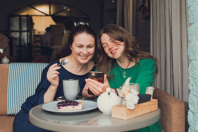 Two women talking and drinking coffee in cafe