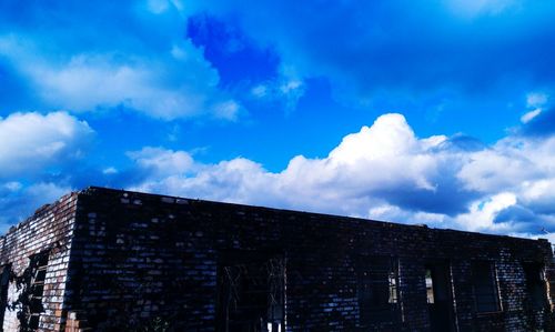 High section of built structure against blue sky