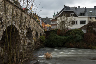 Buildings by river in town