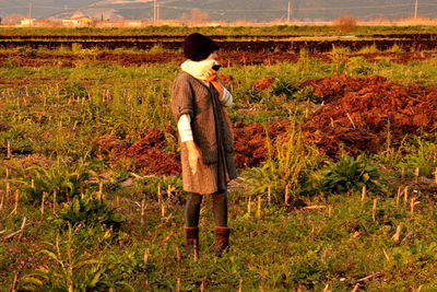 Full length of woman standing on field