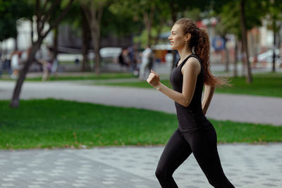 Side view of woman exercising in park