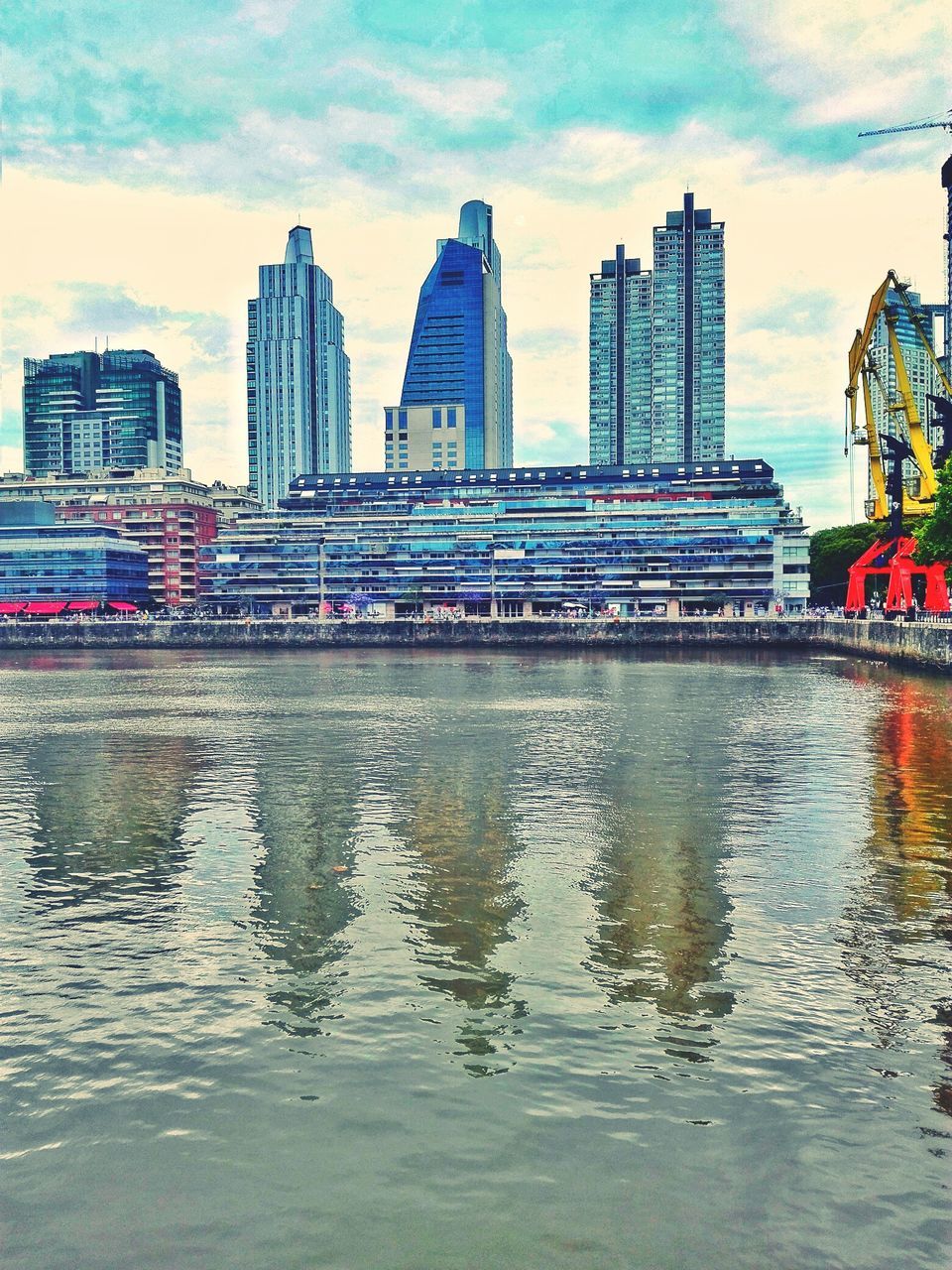 VIEW OF SKYSCRAPERS AT WATERFRONT