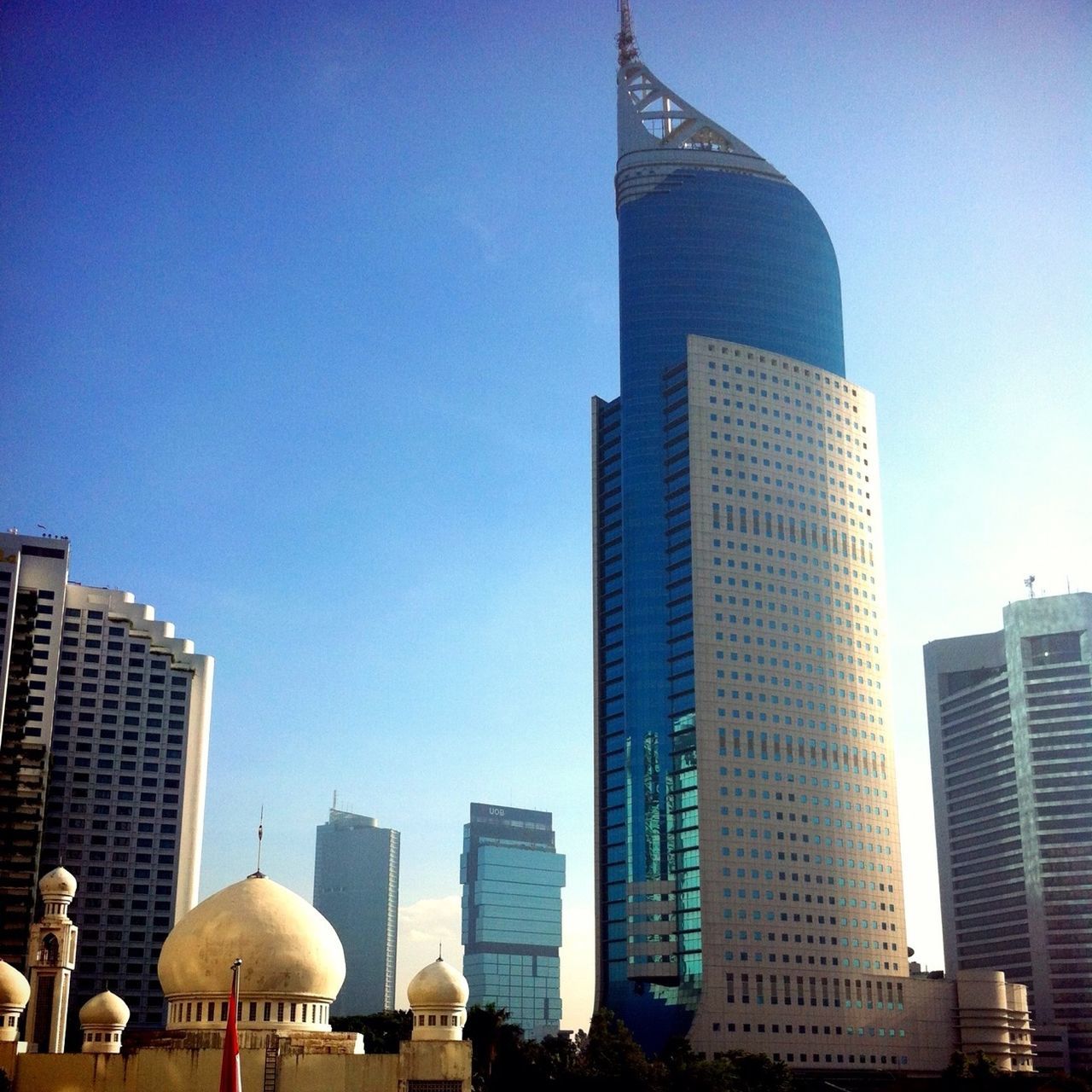 building exterior, architecture, built structure, skyscraper, city, clear sky, tall - high, tower, modern, office building, urban skyline, capital cities, low angle view, financial district, travel destinations, cityscape, blue, famous place, city life, international landmark