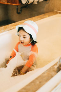 High angle view of cute baby girl in snow