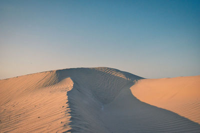 Scenic view of desert against clear sky