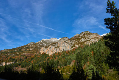 Low angle view of mountain against blue sky