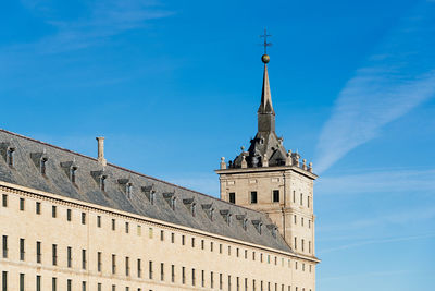 Low angle view of historical building against blue sky