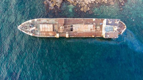 Directly above shot of shipwreck on sea