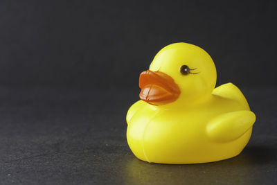 Close-up of yellow toy over black background