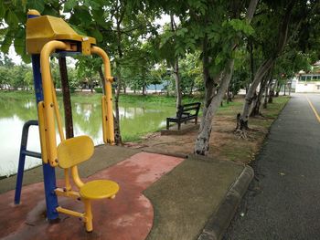 Empty park bench by playground