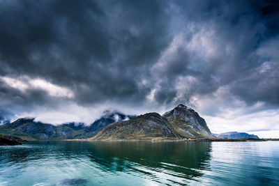 Scenic view of lake and mountains against sky