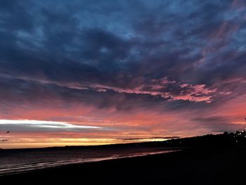 Scenic view of dramatic sky over sea during sunset