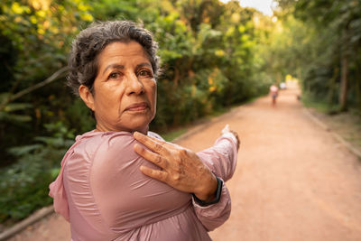 Portrait of senior woman exercising outdoors