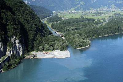 High angle view of river amidst trees against sky