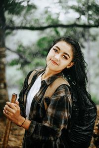 Portrait of young woman standing outdoors